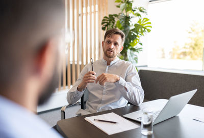 Male boss speaking with recruit