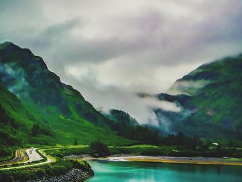 Scenic view of mountains against cloudy sky