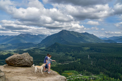 Full length of man looking at mountains against sky