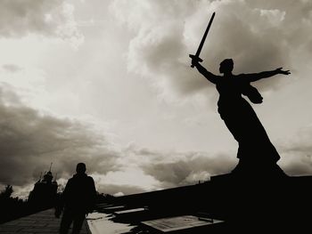 Low angle view of silhouette statue against sky