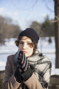 Portrait of young woman wearing hat during winter