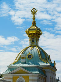 Low angle view of statue of building against cloudy sky