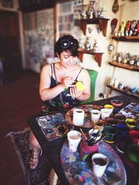 Woman sitting on table