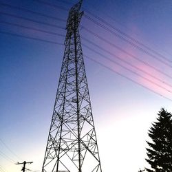 Low angle view of electricity pylon against clear sky