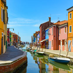 Boats in canal in city