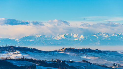 High angle view of snowcapped mountains against blue sky