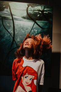 Portrait of woman with arms raised