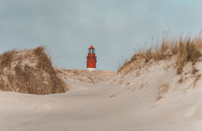 Lighthouse on snow covered landscape