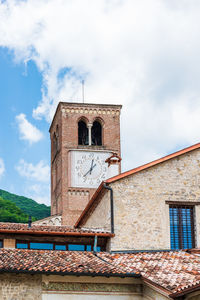 Low angle view of clock tower against sky