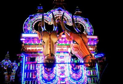 Illuminated ferris wheel at night