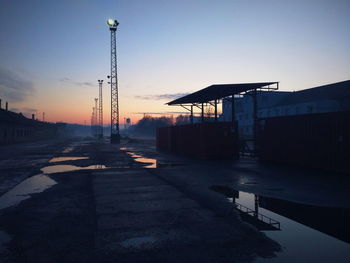 View of street lights at industrial area during sunset