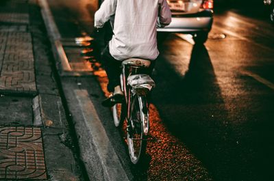 Low section of man cycling on bicycle