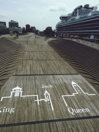 High angle view of text on road against buildings in city