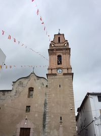 Low angle view of clock tower against sky