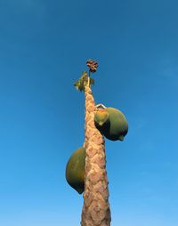 Low angle view of statue against clear blue sky
