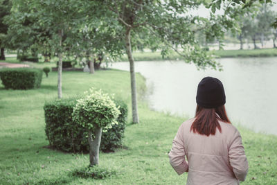 Rear view of woman standing in park