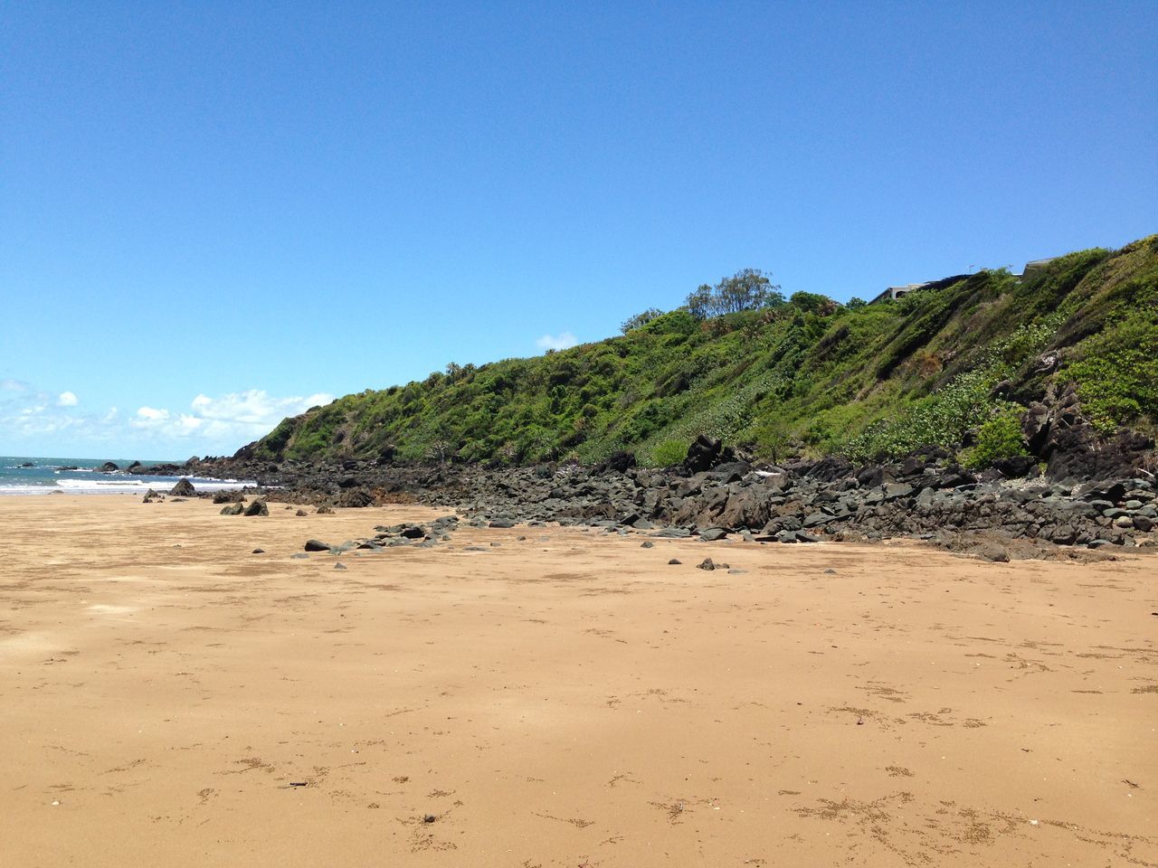 sand, beach, clear sky, tranquil scene, tranquility, blue, sea, scenics, mountain, shore, beauty in nature, copy space, water, nature, sky, coastline, idyllic, sunlight, day, remote