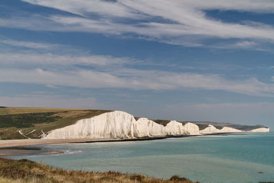 Cliffs by sea against sky at seven sisters country park