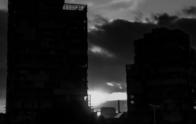 Buildings against cloudy sky