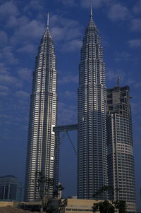 Low angle view of petronas towers against sky at dusk