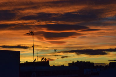 Low angle view of silhouette buildings against sky during sunset