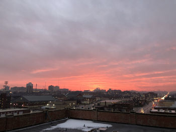 High angle view of illuminated buildings against sky at sunset