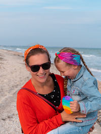 Young woman wearing mask on beach