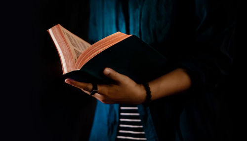 Close-up of hand holding book