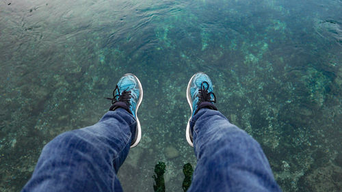 Low section of man in sea