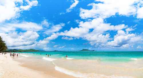 Scenic view of beach against blue sky