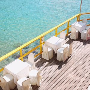 High angle view of restaurant tables on boat deck