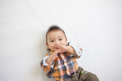 Portrait of smiling boy against white background