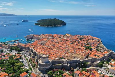 High angle view of townscape by sea against sky