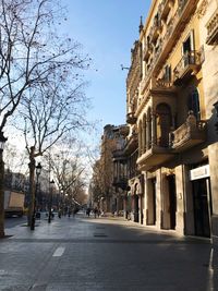 Street amidst buildings in city against sky