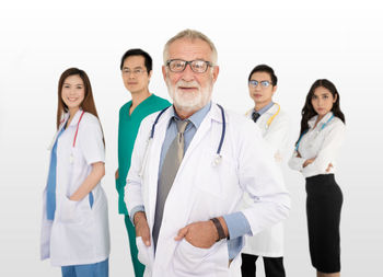 Portrait of friends standing against white background