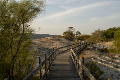 Wooden bridge against sky