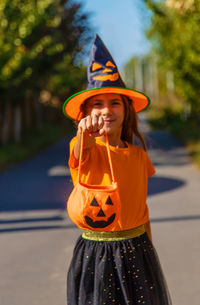 Portrait of young woman wearing hat standing outdoors