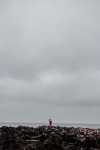 Man looking at sea against sky