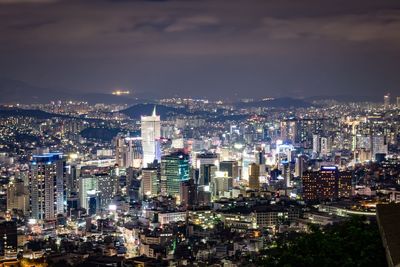 Aerial view of city lit up at night