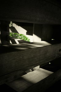 Close-up of wooden table against building