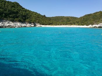 Scenic view of sea against clear blue sky