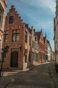 Empty street with brick typical buildings in bruges. a town full of canals in belgium.