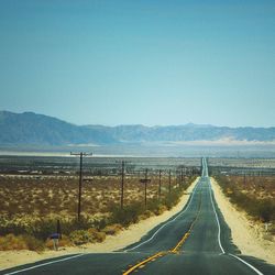 Empty county road against sky