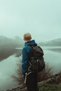 Man exploring a misty welsh valley 