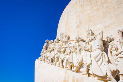 Low angle view of statue against clear blue sky