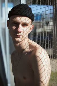 Portrait of shirtless young man wearing hat