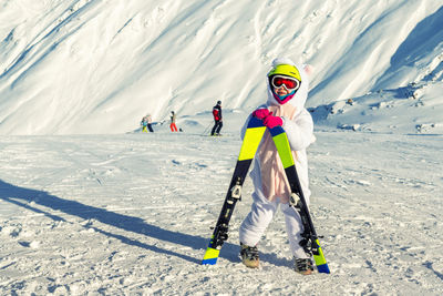 Girl skiing on snow covered mountain