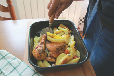 Close-up of hand holding food in bowl