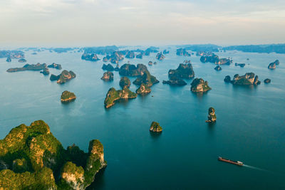 Aerial view of rock formation in sea against sky