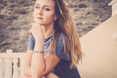 Thoughtful woman looking away while standing outdoors